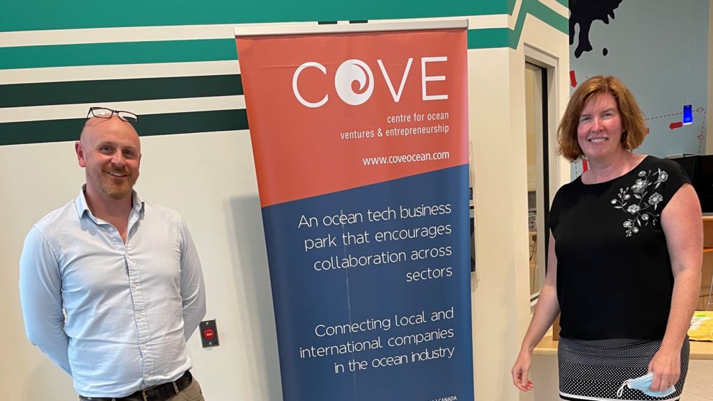 Man and woman standing either side of Centre for Ocean Ventures and Entrepreneurship (COVE) Banner